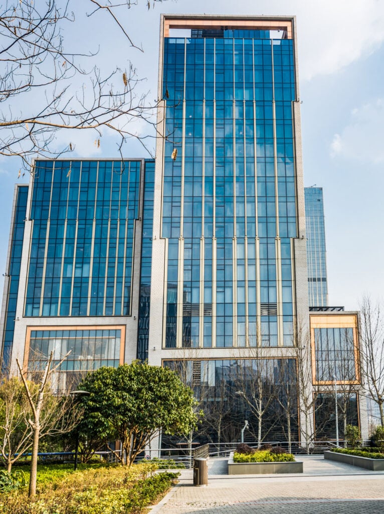 Modern commercial business center with glass facade and landscaped surroundings, representing prime office space available in Connecticut.
